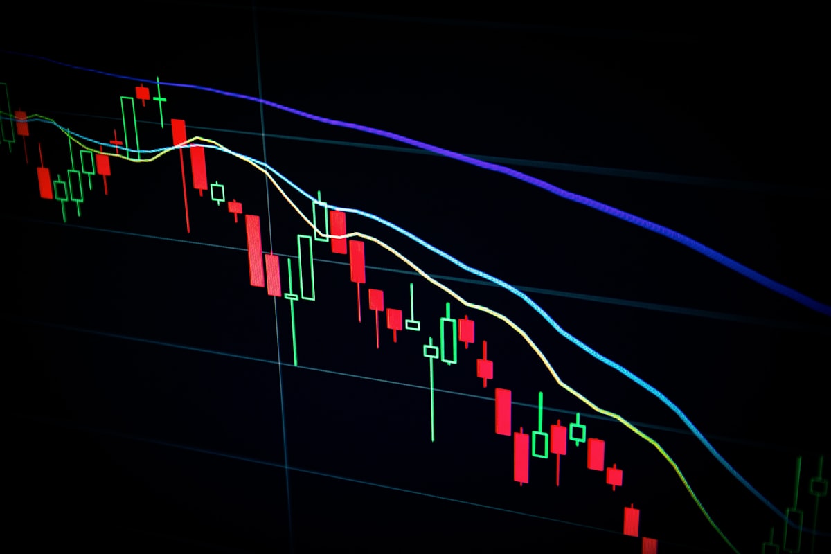 Person looking at financial charts on a laptop screen